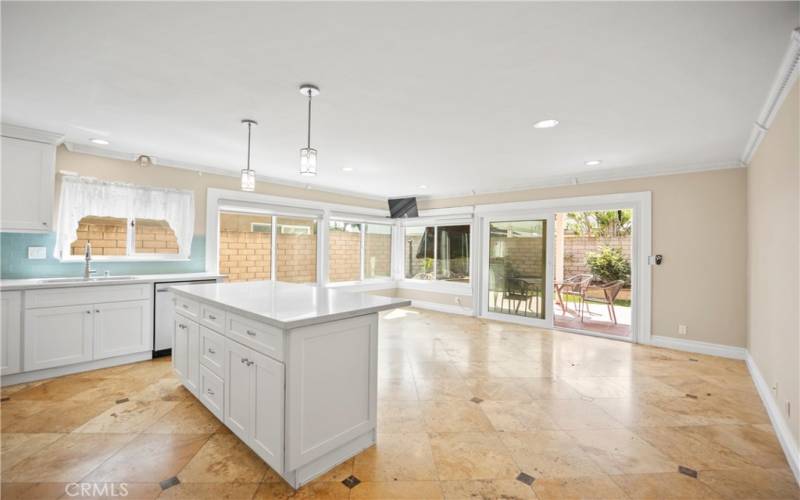 Kitchen open to family room and backyard views.