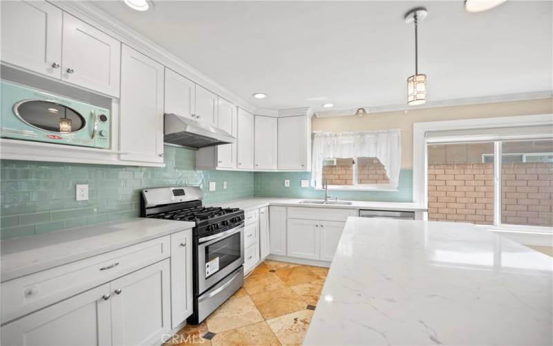 Kitchen has a large pantry and plenty of cabinet storage.