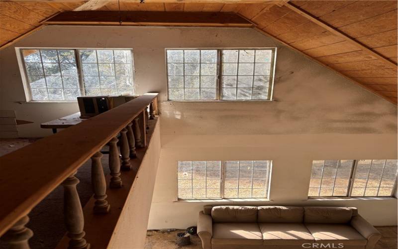 Looking down into living room from upstairs loft.