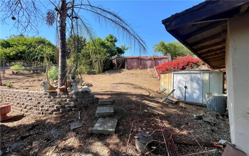 Metal shed behind detached garage