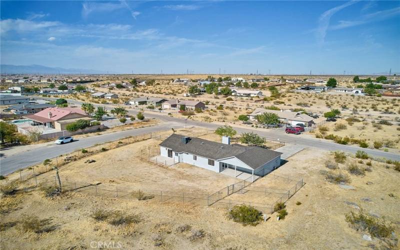 Back aerial view of corner lot #