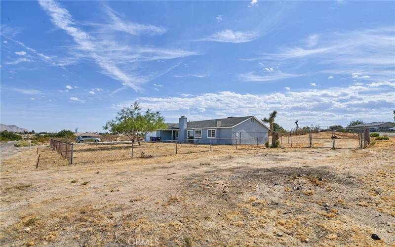 Corner view of ample driveway and entrance to back yard.