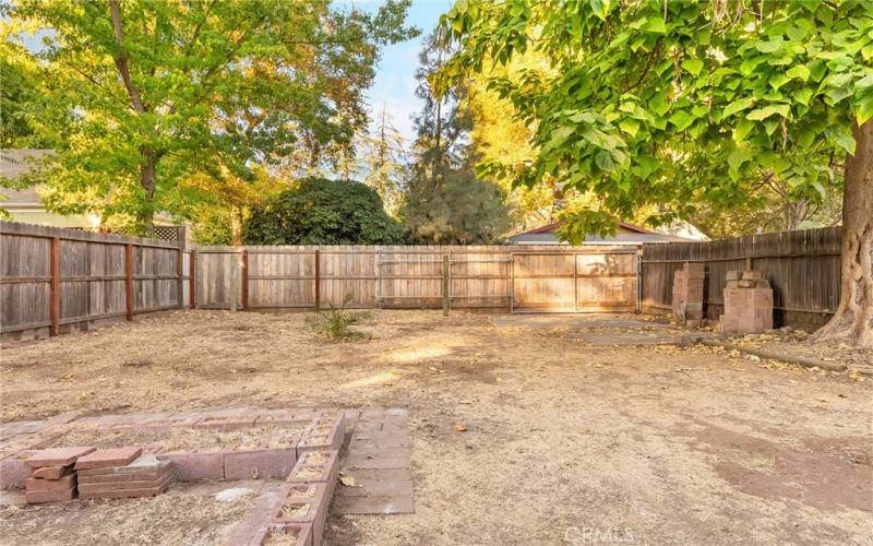 Rear Yard.  Back Fence Has an Automobile Gate (on right) and a Pedestrian Gate (on left)