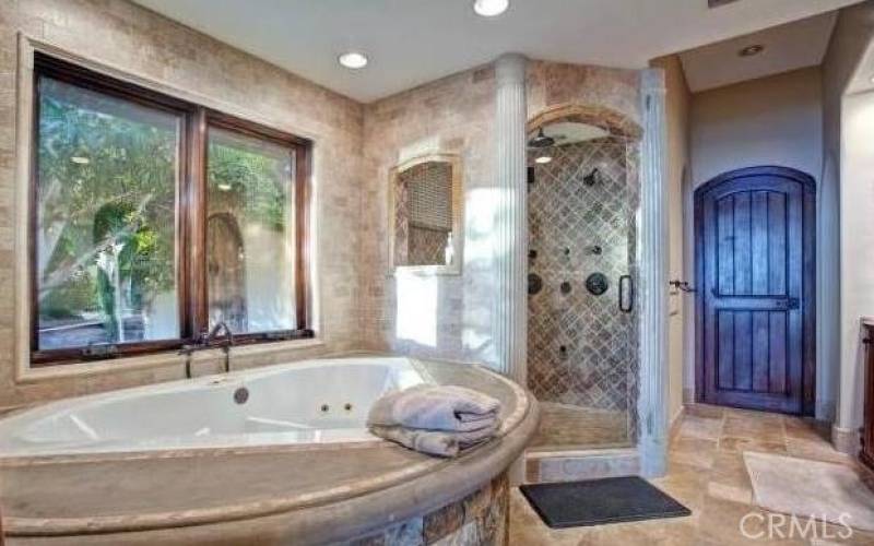 Main bedroom bath with tub and shower and large walk in double closets.