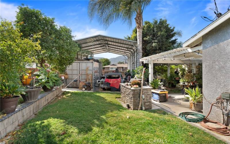 Backyard view w/ visible RV Parking and Cover