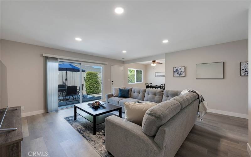 Living Room with slider access to backyard dining table and BBQ