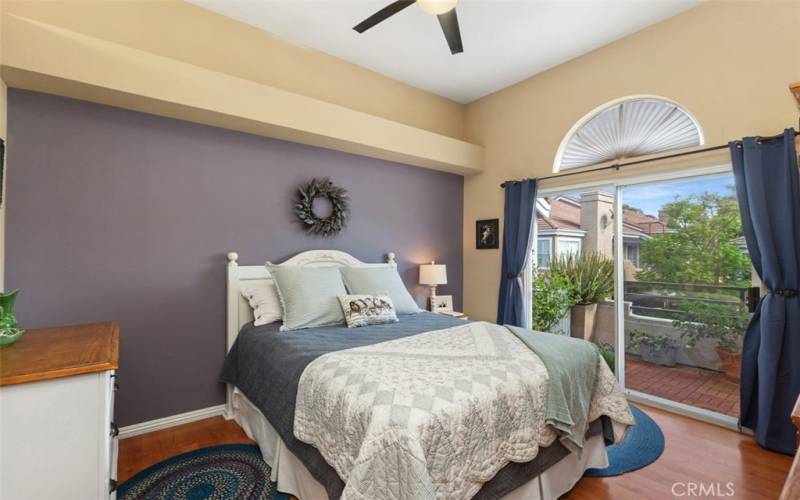 Primary bedroom with slider doors that open onto the private patio.