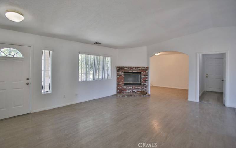 living room with fireplace and view to bonus room/laundry room