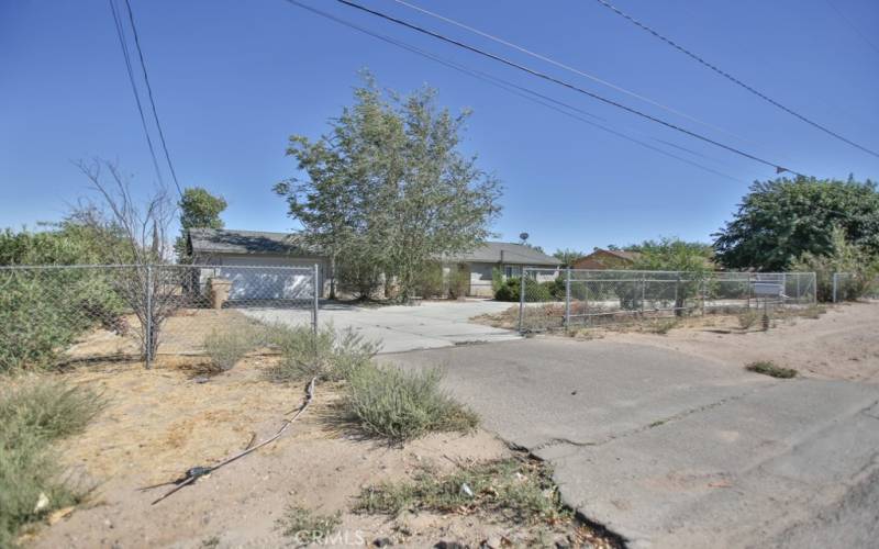 View from street -fenced property with circular driveway