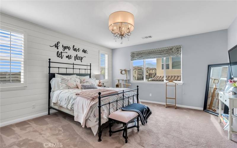 Primary bedroom has lots of natural light