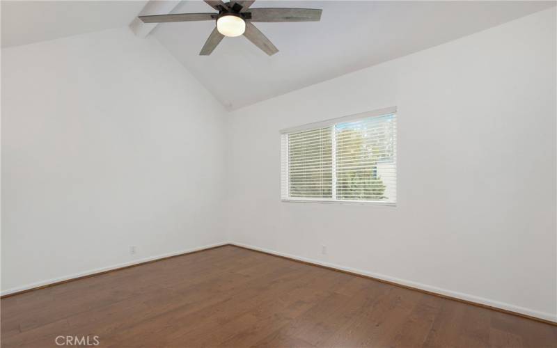 owners suite bedroom with high ceilings and 6-blade ceiling fan