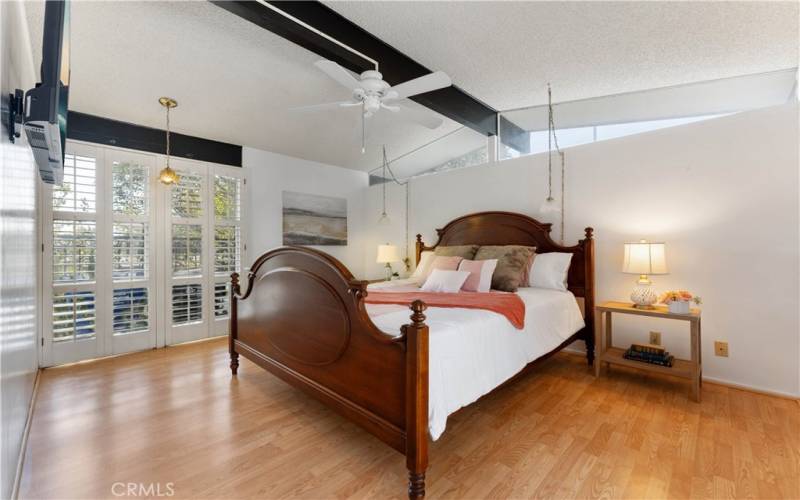 Primary bedroom with plenty of window light. This room is closest to the front yard. Small accent window above bed faces the front yard