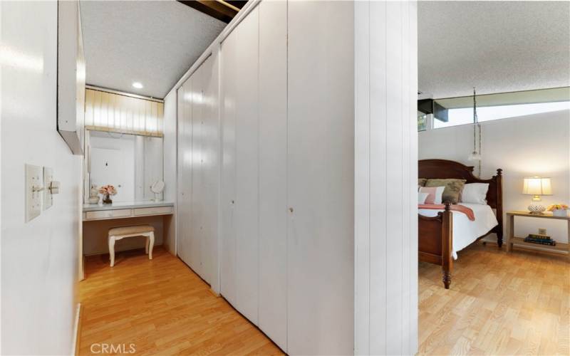 Closet and vanity to primary bedroom.