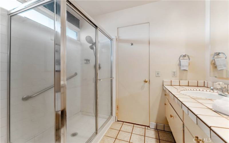 Large shower with handrail, double sinks in primary en suite.