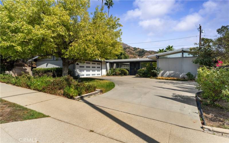 Sidewalks to enjoy for a stroll among the neighbors. Mid Century home with 2 car garage. Door faces West.