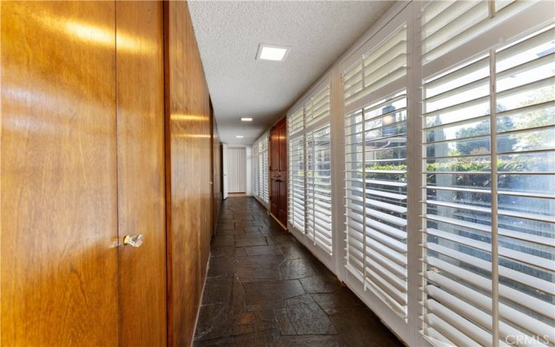 This is a long entry with closet spaces to store shoes and whatever else is needed. Throughway at the distance leads to the hallway to bedrooms/baths/laundry.