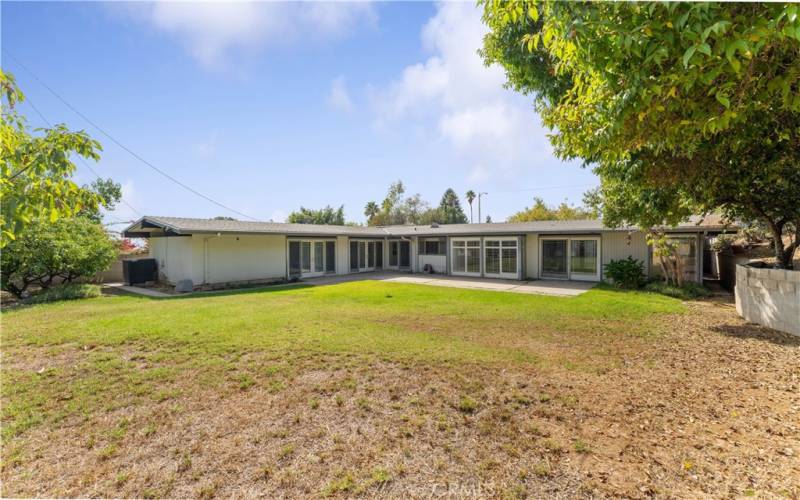 Fruit trees and spacious yard. AC unit at backside of the 3rd bedroom.