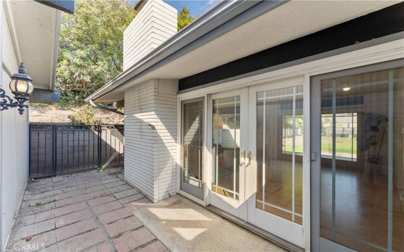 Sliders from formal living room allows to walk through gate to access garage.