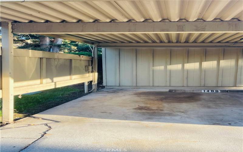 Covered designated parking space next to garage
