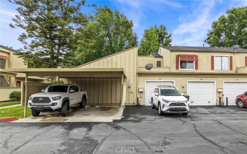 Assigned covered parking spot and attached garage behind  the home