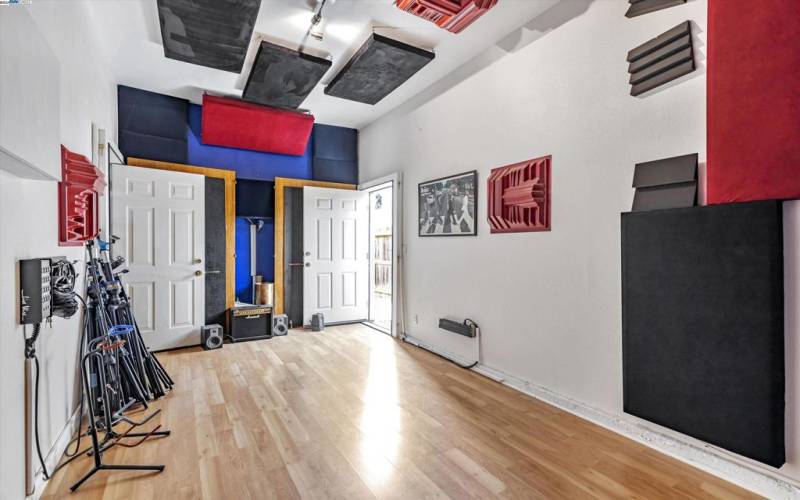 One garage of the 3 car garage converted to a sound proof studio.