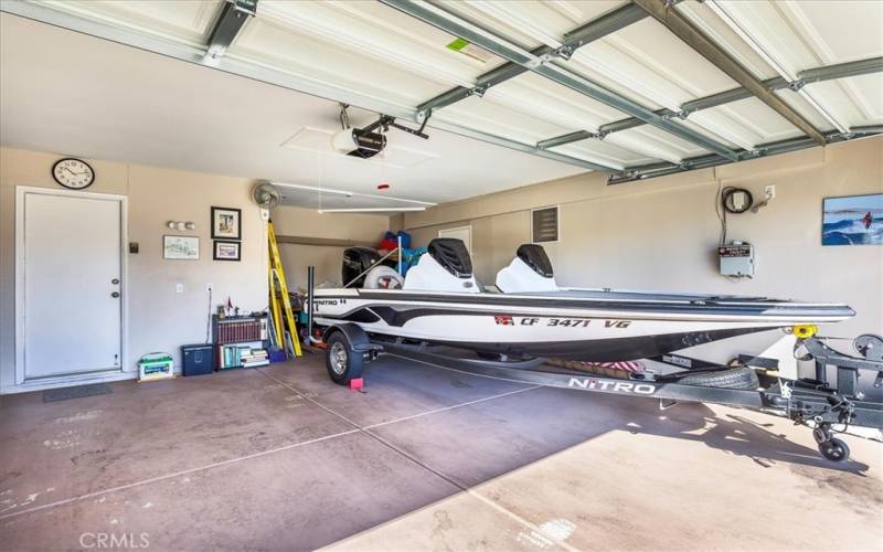 Deep 2 car garage that fits a boat, with plenty of room for storage.