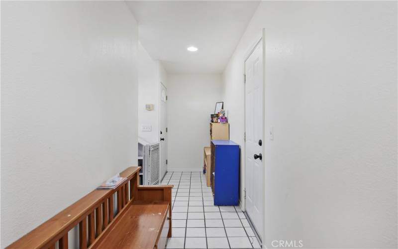 Hallway with attached garage and outdoor exit