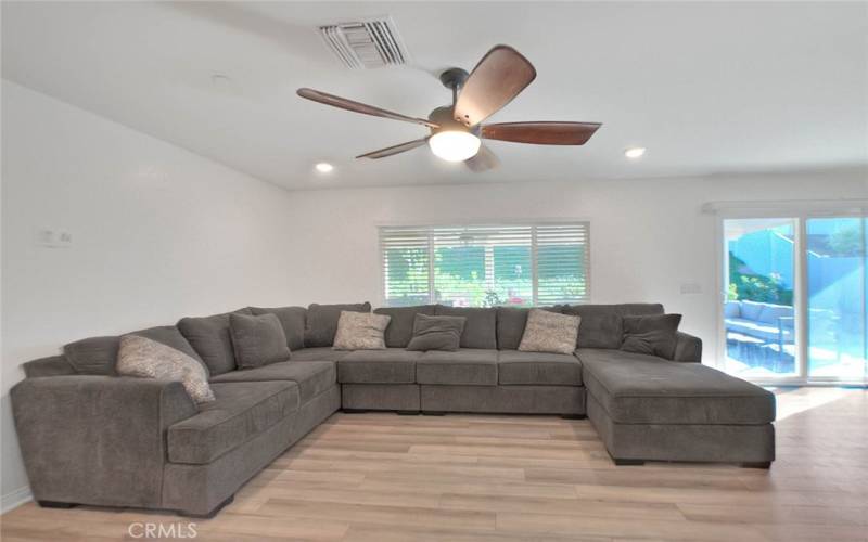 Oversized Living Room with Ceiling Fan and Private Backyard Views!