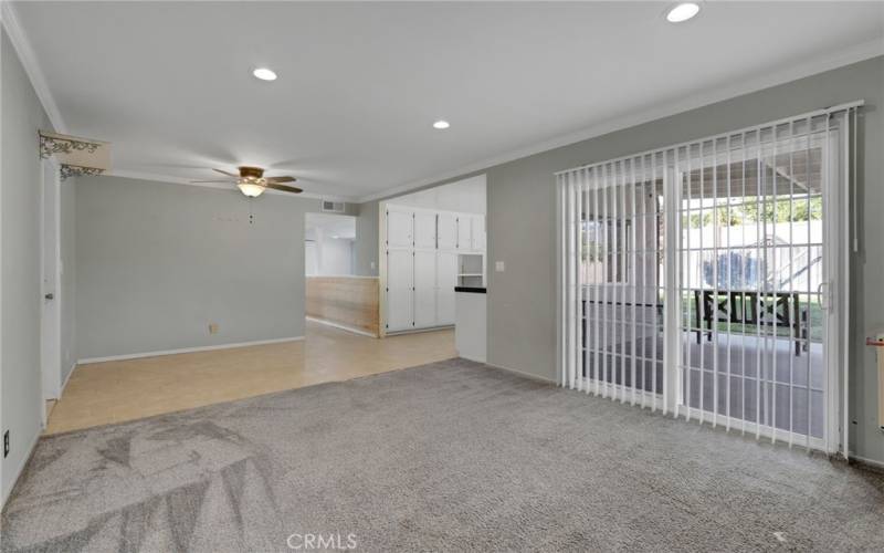 Family room with recessed lighting.  Door to left leads to 2 car garage.  Sliding door leads to covered patio in backyard.