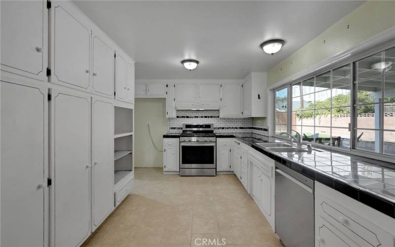 Kitchen with windows that open to covered patio for easy access to and from kitchen.