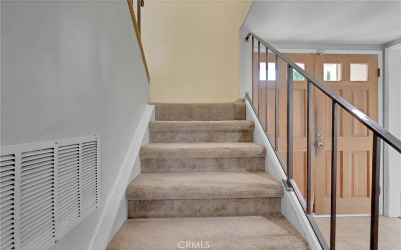 Stairs from main door entry leading to bedrooms