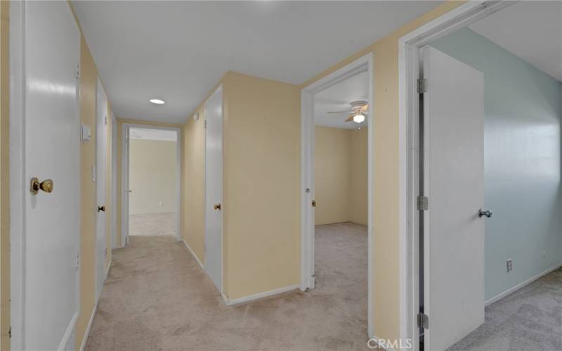 View from 1st bedroom, showing the other 3 bedrooms with 2 hallway closets & hallway bathroom