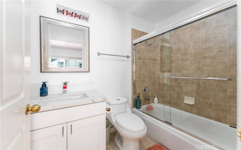 En-suite primary bathroom with bathtub shower