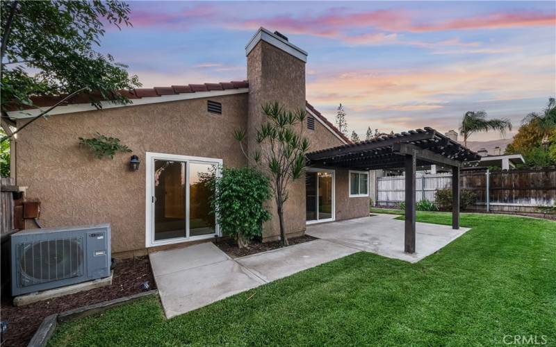 Backyard with concrete slab & patio cover