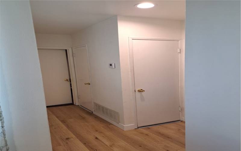 19. hallway looking to AC & heater closets & master bd