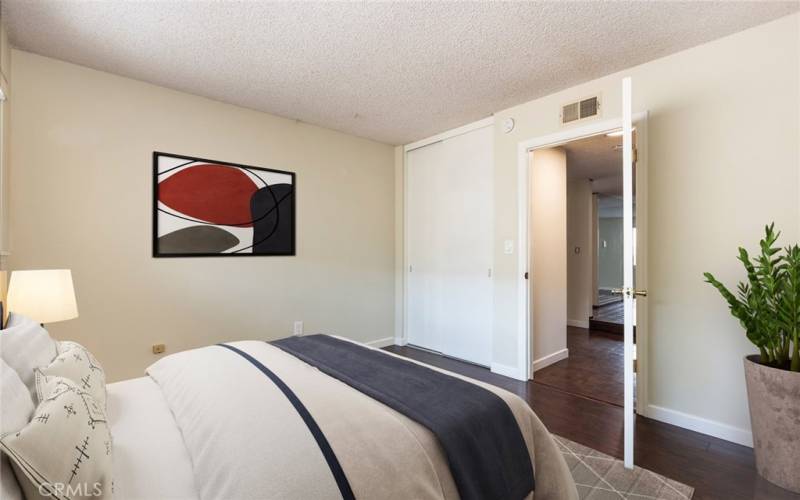 Virtually staged bedroom between the master and third bedroom