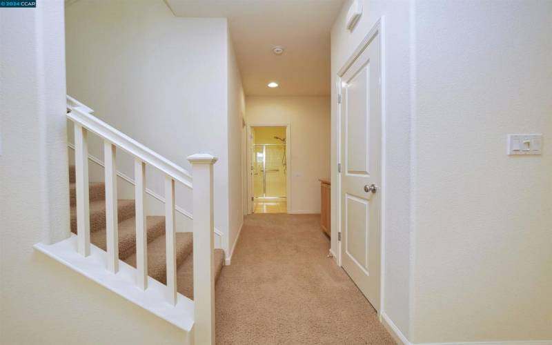 Stairs and Hallway to Downstairs Bedroom and Bathroom and Garage