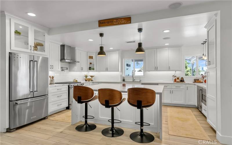 Luxurious chef's kitchen is incredible and remodeled only 5 years ago. Soft-close cabinetry, small drink refrigerator, built-in microwave drawer, quartz countertops, 2-mo-old soft water system just for the kitchen, recessed lighting and LED-lit glass cabinets, and so much more!