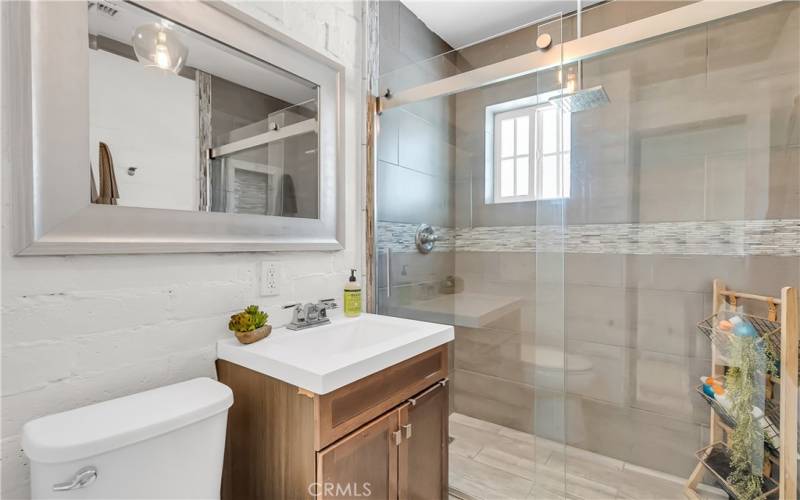 Remodeled hallway bathroom shared by two secondary bedrooms.