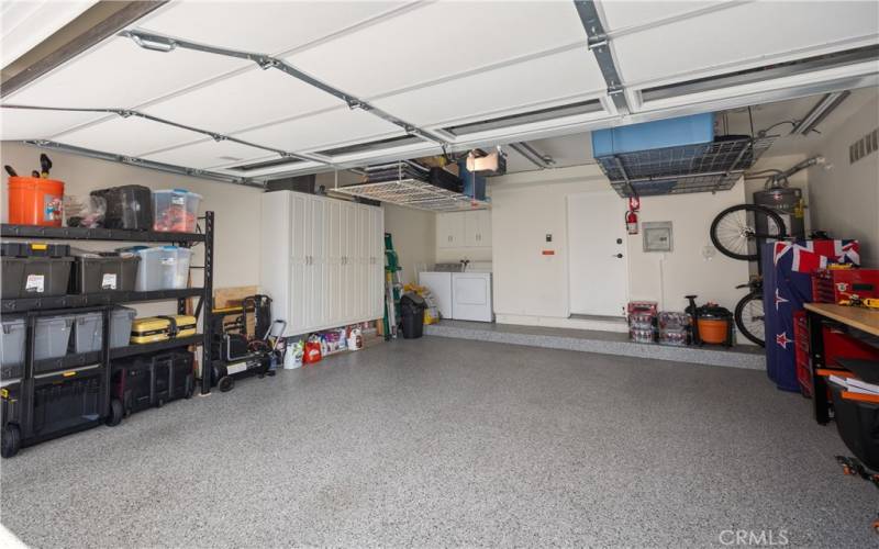 Large 2-car Garage with Roll-up Door Organized Storage Space and Epoxy-coated Floors