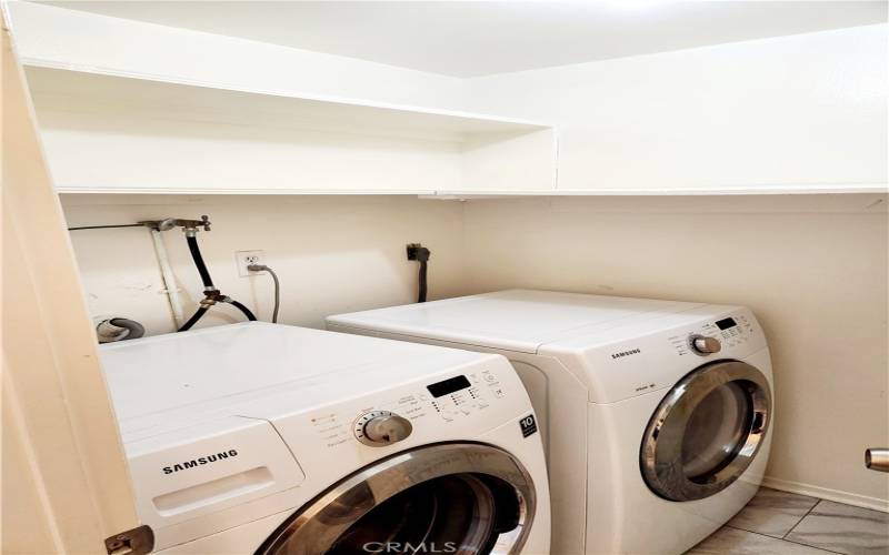 Downstairs laundry room with storage space