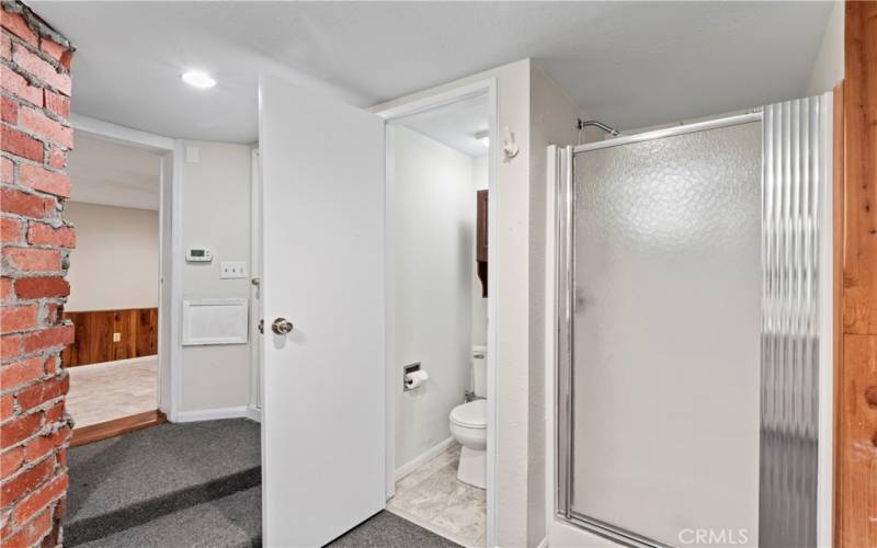 The water closet, located next to the utility room, provides privacy.