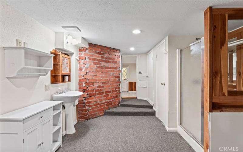 This bathroom, adjoining the expansive family room/bedroom, provides access to an additional bonus area.