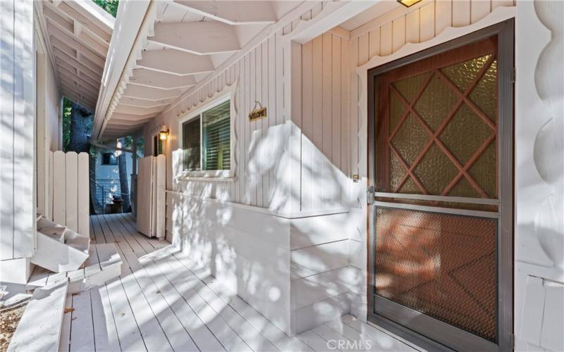 The entryway offers access to the storage area under the garage, a gate leading to the enclosed space, and an alternate entrance to the kitchen.