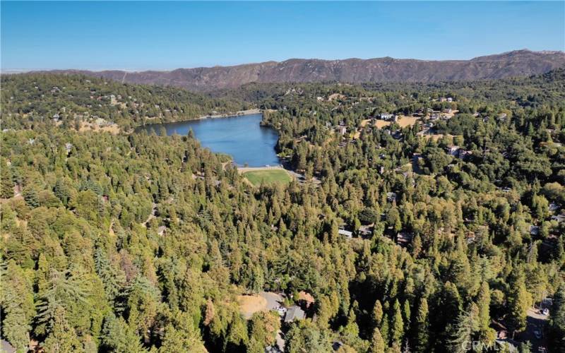 Nestled above a seasonal stream, this location boasts a beautiful setting with convenient, quick, access to the lake