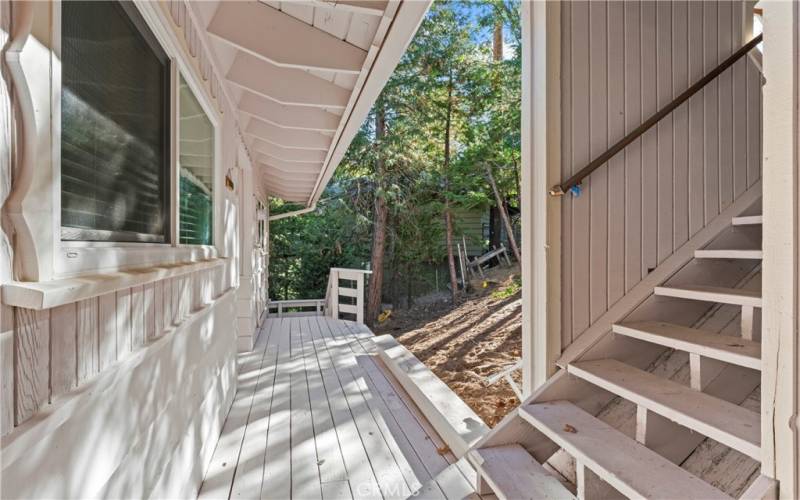 Covered stairs leading from the garage and parking area.