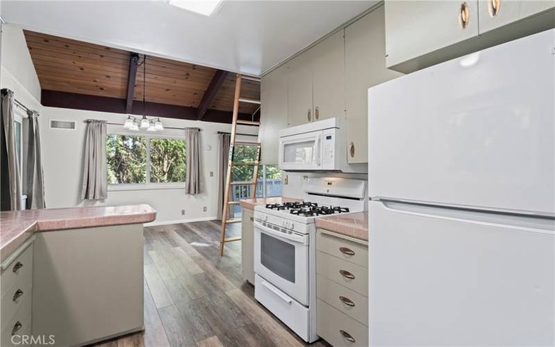 A kitchen that opens to a fenced yard and provides convenient access to the deck.