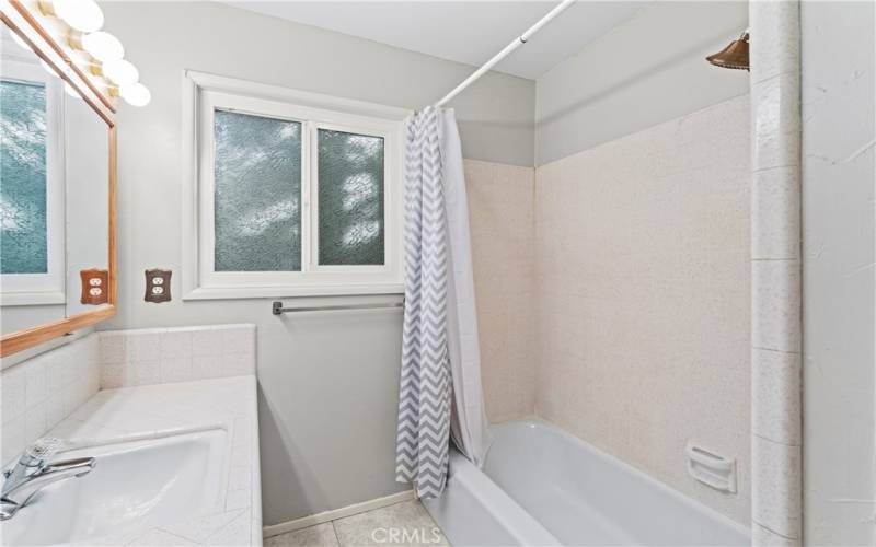 A full guest bathroom is situated between the guest bedroom and office/bonus space.