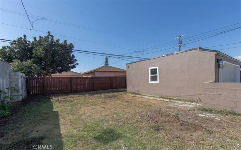 Large backyard recently seeded with sprinklers