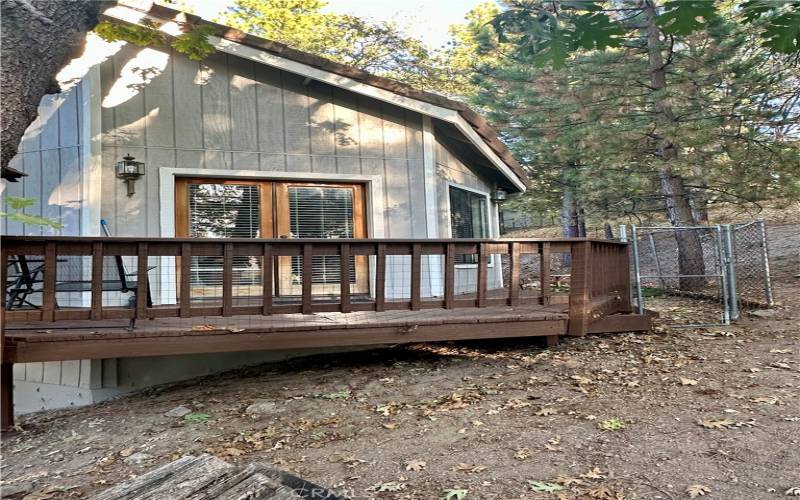 Primary bedroom's private deck with dog run access